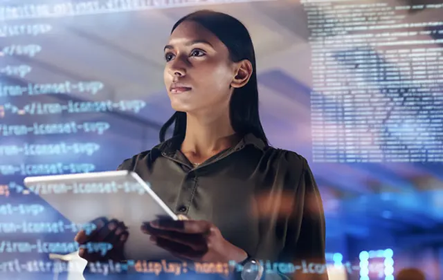 A tech-focused scene featuring a person holding a tablet, surrounded by superimposed lines of code. 