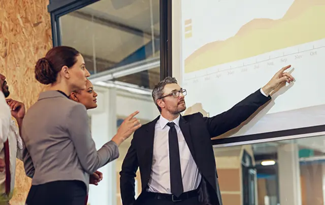 A business presentation in a modern office setting. 