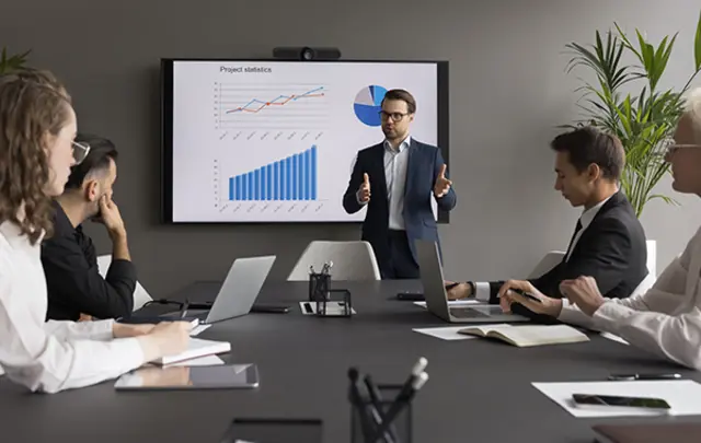 A professional business meeting in a modern conference room.