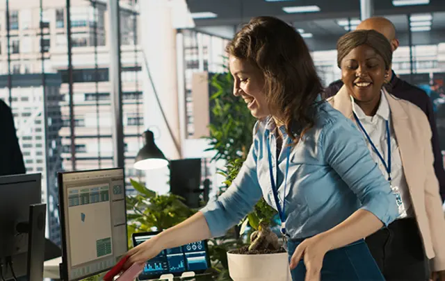 A bright, modern office scene with three colleagues.