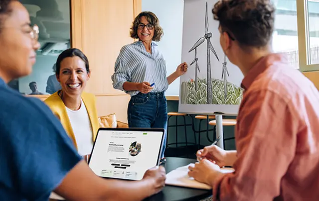 A diverse group of four professionals collaborates in a modern office. 