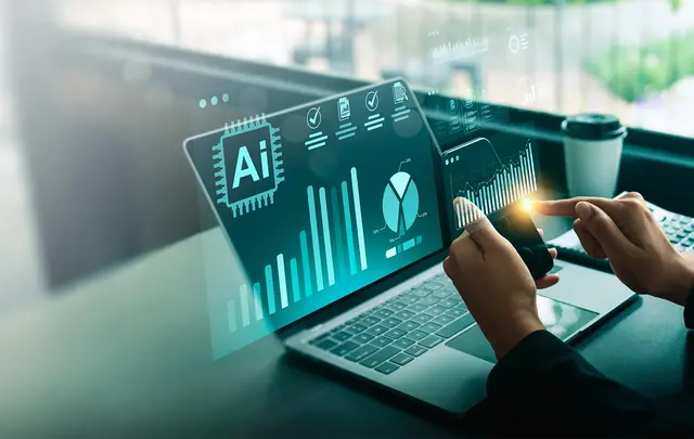 A person uses a laptop and smartphone to view AI-powered financial analytics dashboards.