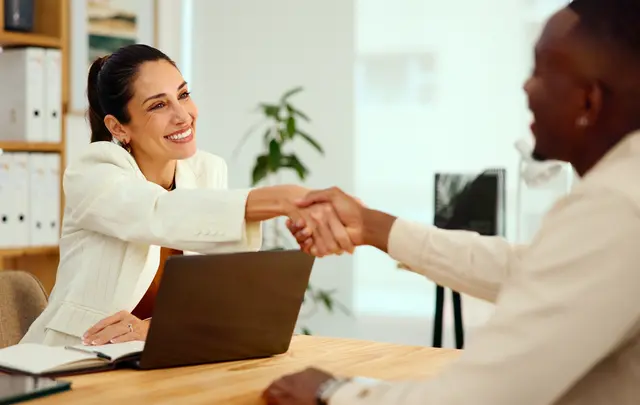 A professional onboarding or interview meeting in a modern office.