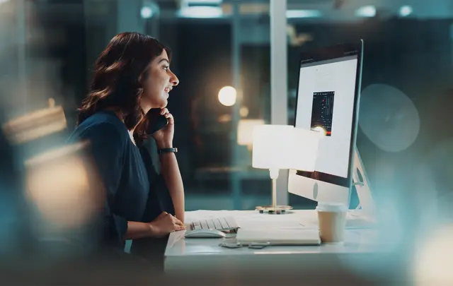 Finance leader reviewing AI-powered workforce and financial planning data on a digital dashboard.