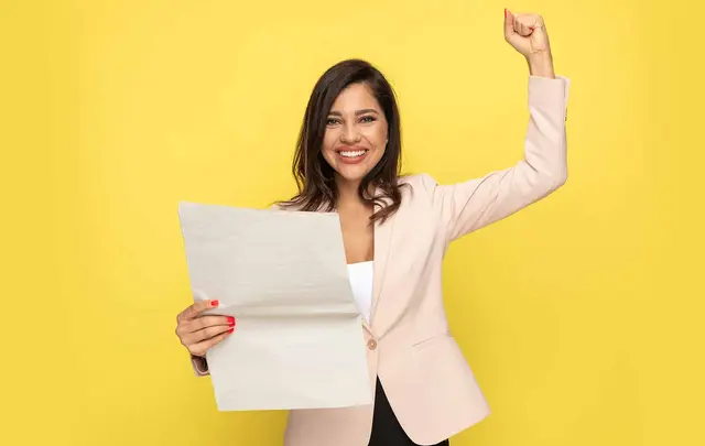 person with paper on yellow background
