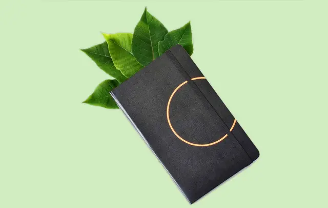 Black agenda with leaves sticking out