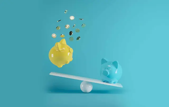 a blue and a yellow piggy bank on a seesaw. One piggy bank is losing its money