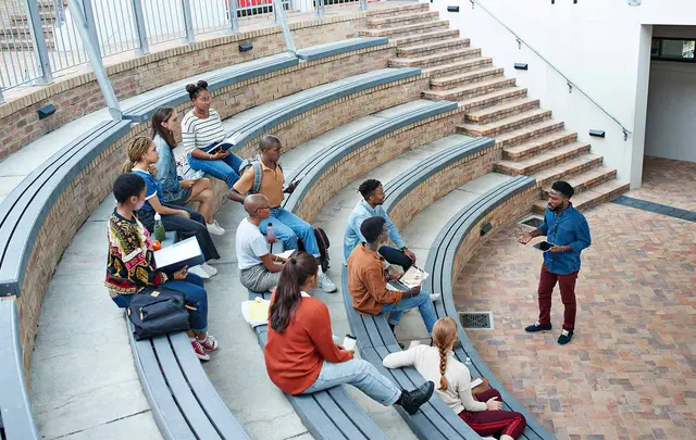 students sat in an auditorium listening to their tutor