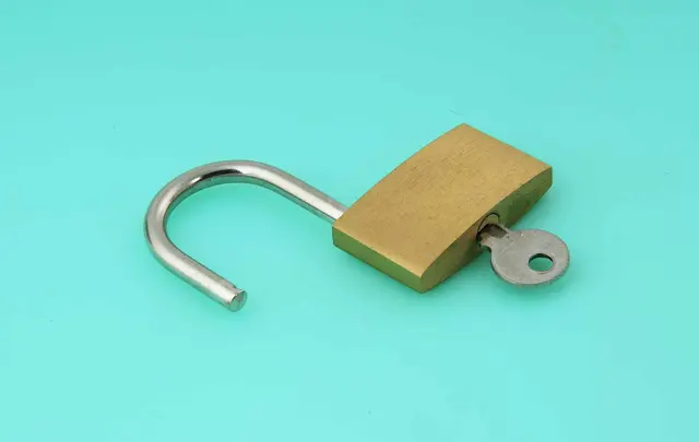 an unlocked padlock with the key inserted