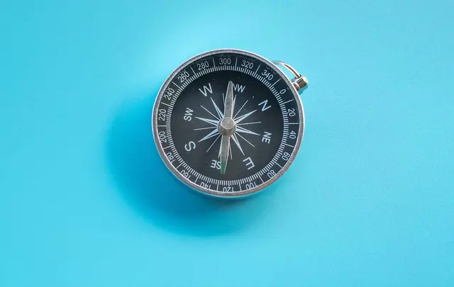 a compass on a blue background