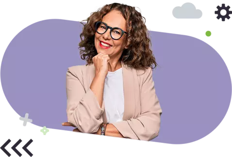 A smiling woman with curly hair and glasses, wearing a blazer, with a thoughtful pose on a purple background. 