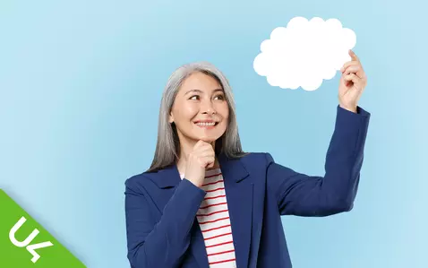 Image showing a woman holding up a paper cutout cloud
