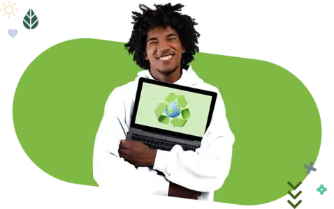 A smiling person in a white hoodie holds a laptop with a recycling symbol on the screen. 