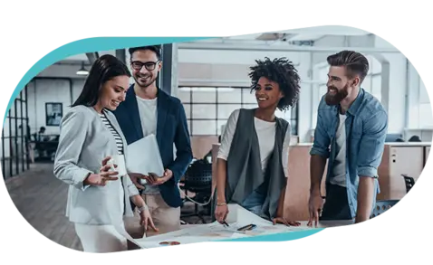 Four colleagues gathered around a table in a modern office, engaged in a collaborative discussion. 