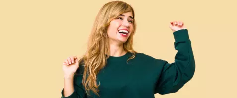 Happy woman on orange background