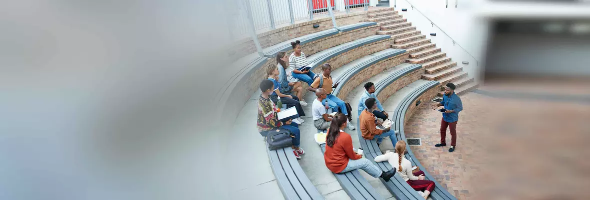 students sat in an auditorium listening to their tutor