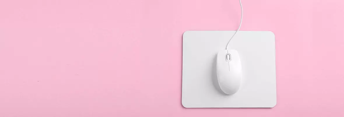 a white mouse on a white mouse mat on a pink background