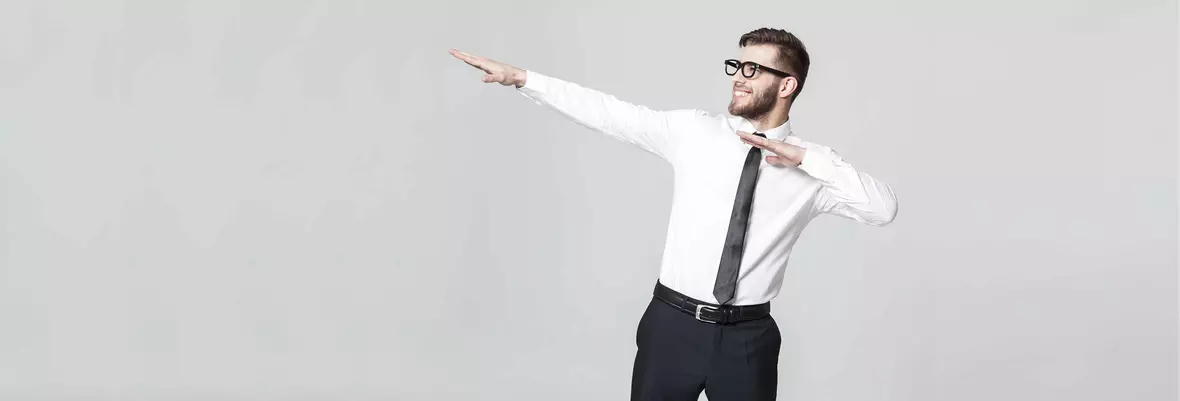 a young smartly dressed man in glasses dabbing