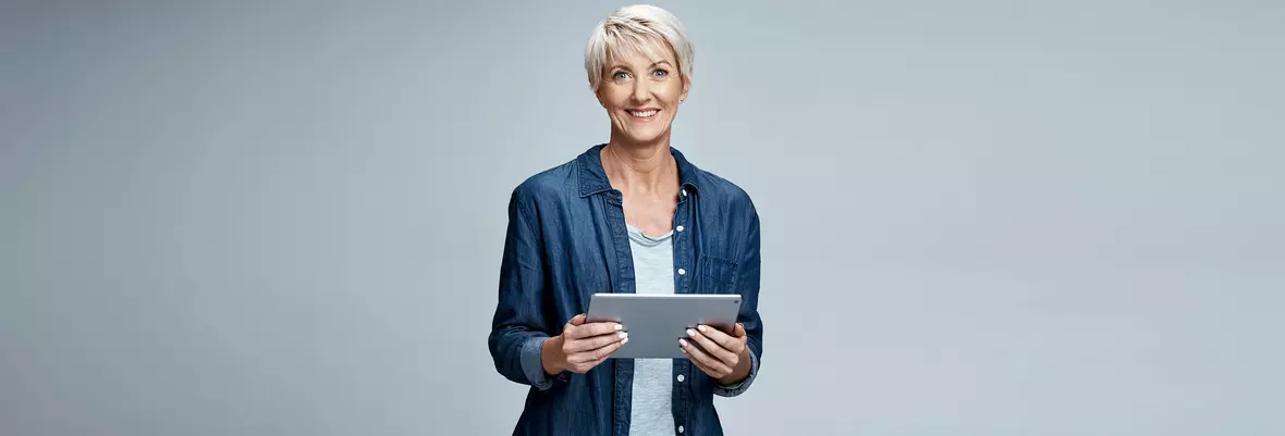 person smiling with Ipad in hands