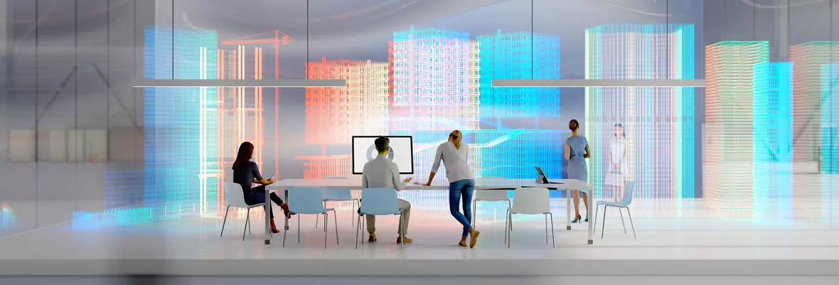 3 employees say around a table in a futuristic office space