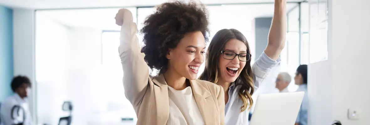 people holding laptop cheering, celebrating