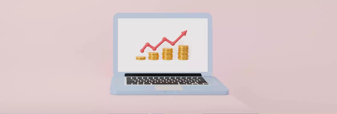 laptop with graph and coins