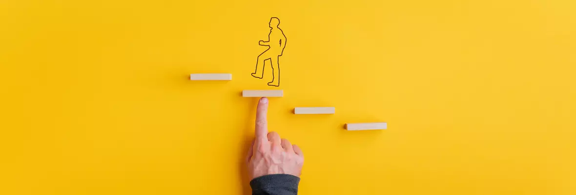 Finger pointing at drawn man going up small steps 