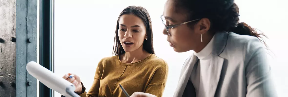 people looking at paper 