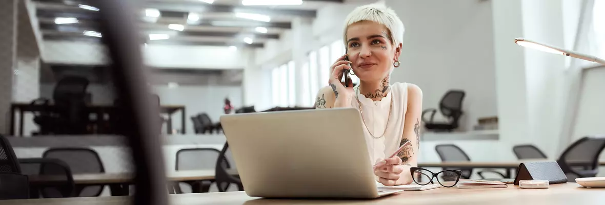 young tattooed business woman smiling