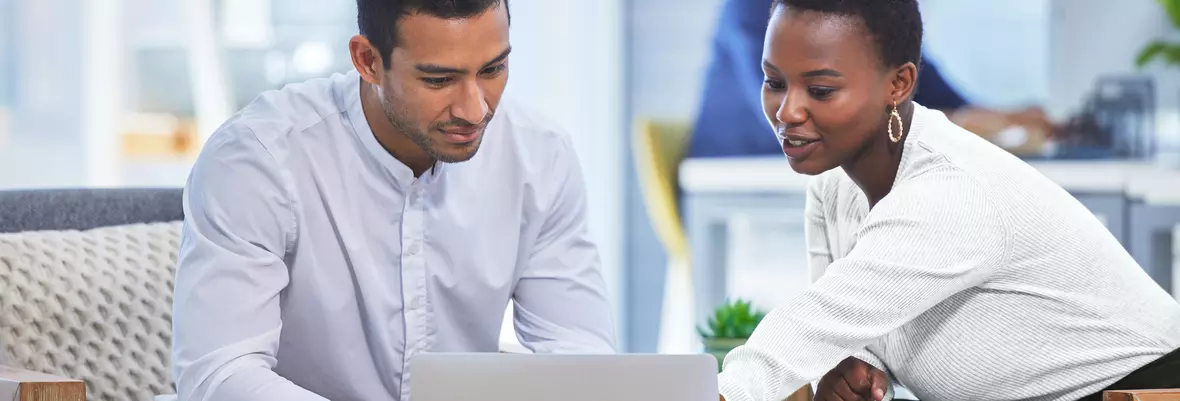 Businesspeople looking at laptop