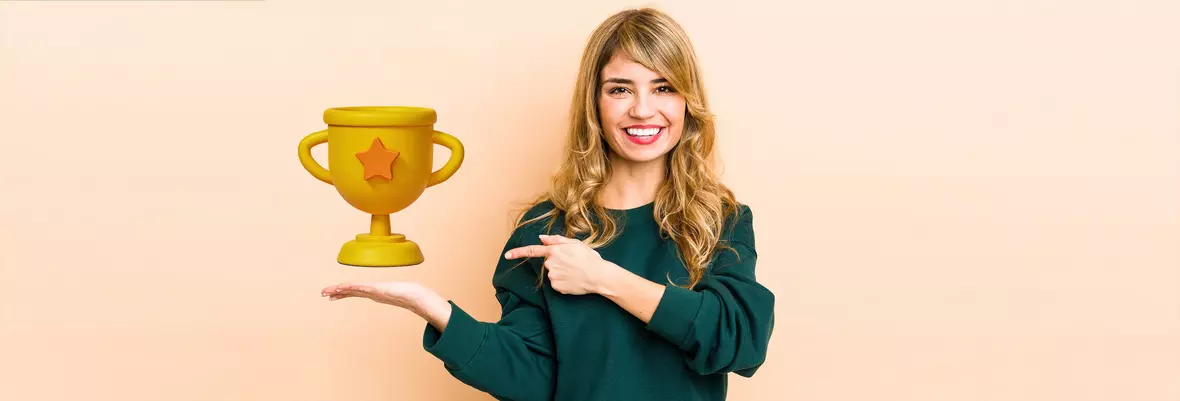 woman smiling holding trophy
