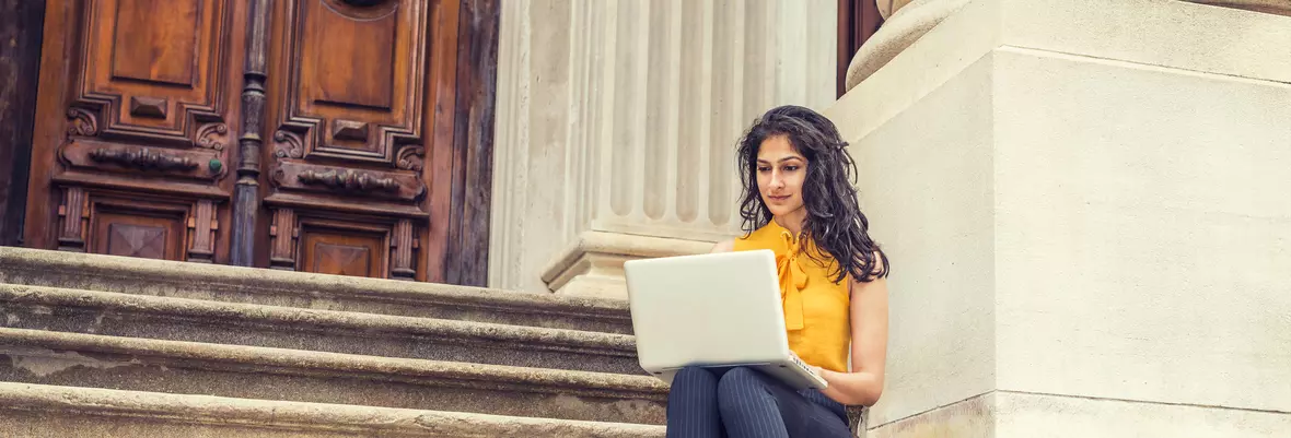 woman with a laptop in stairs