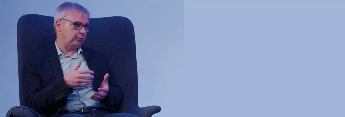 Man with glasses sitting in a chair