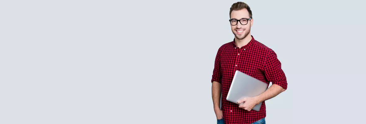 Man in red shirt holding a computer