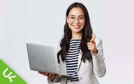 woman, smiling and holding laptop, giving thumbs up sign with free hand