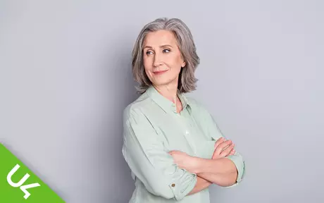 smiling woman, arms folded, looking sideways