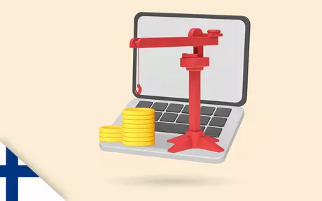 Laptop with a crane and coins on top
