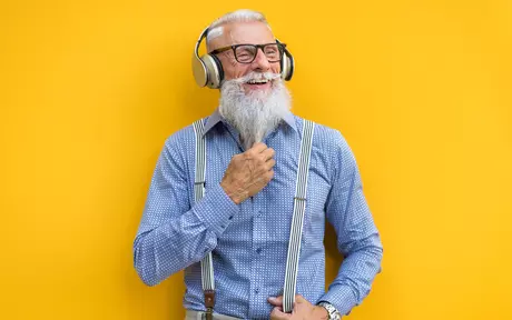 person with headphones on yellow background
