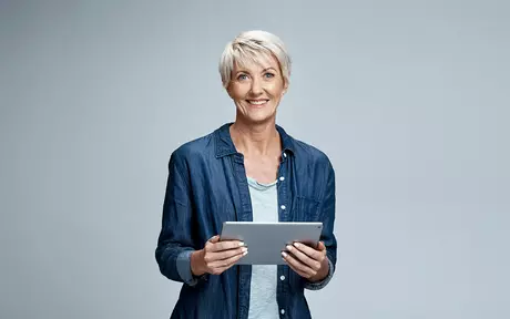 person smiling with Ipad in hands