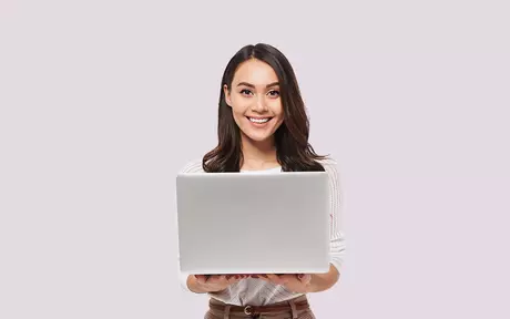 person smiling with laptop