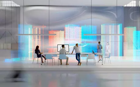 3 employees say around a table in a futuristic office space
