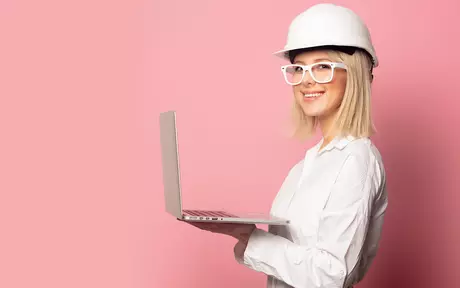 woman with construction helmet and laptop