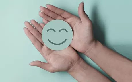 smiley face in hands