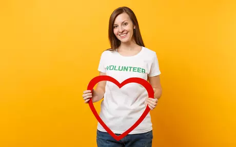 woman with volunteer tshirt and red heart