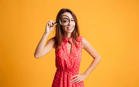 happy woman with magnifying glass