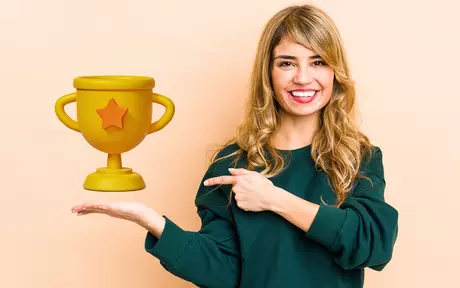 woman smiling holding trophy