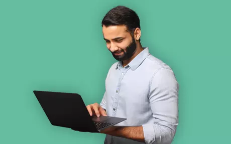 man with a laptop smiling