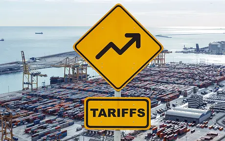 Two bright yellow road signs in the foreground, one featuring an upward-trending arrow and the other labeled 'TARIFFS,' set against an aerial view of a bustling shipping port. 