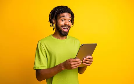 person looking happy at tablet