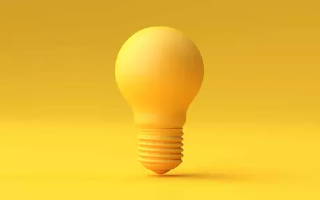 a yellow light bulb with a yellow background